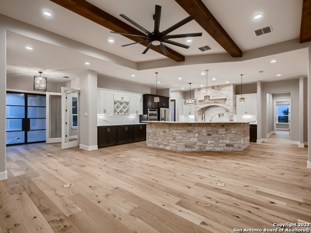208 River Ridge Boerne, TX 78006 - Photo 7 of 38 a view of a kitchen with a sink and a ceiling fan