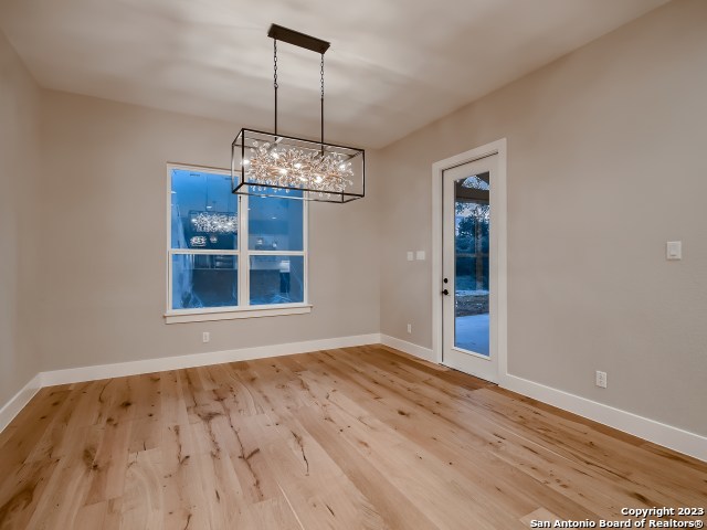 208 River Ridge Boerne, TX 78006 - Photo 8 of 38 a view of an empty room with wooden floor and a window