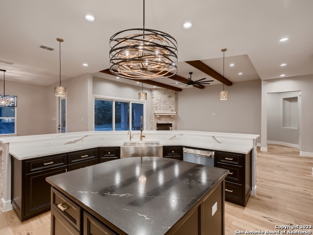 208 River Ridge Boerne, TX 78006 - Photo 9 of 38 a kitchen with a stove a counter space and wooden floor