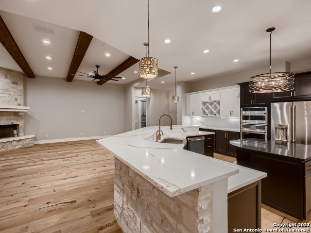 208 River Ridge Boerne, TX 78006 - Photo 10 of 38 a large kitchen with stainless steel appliances kitchen island a large island in the center