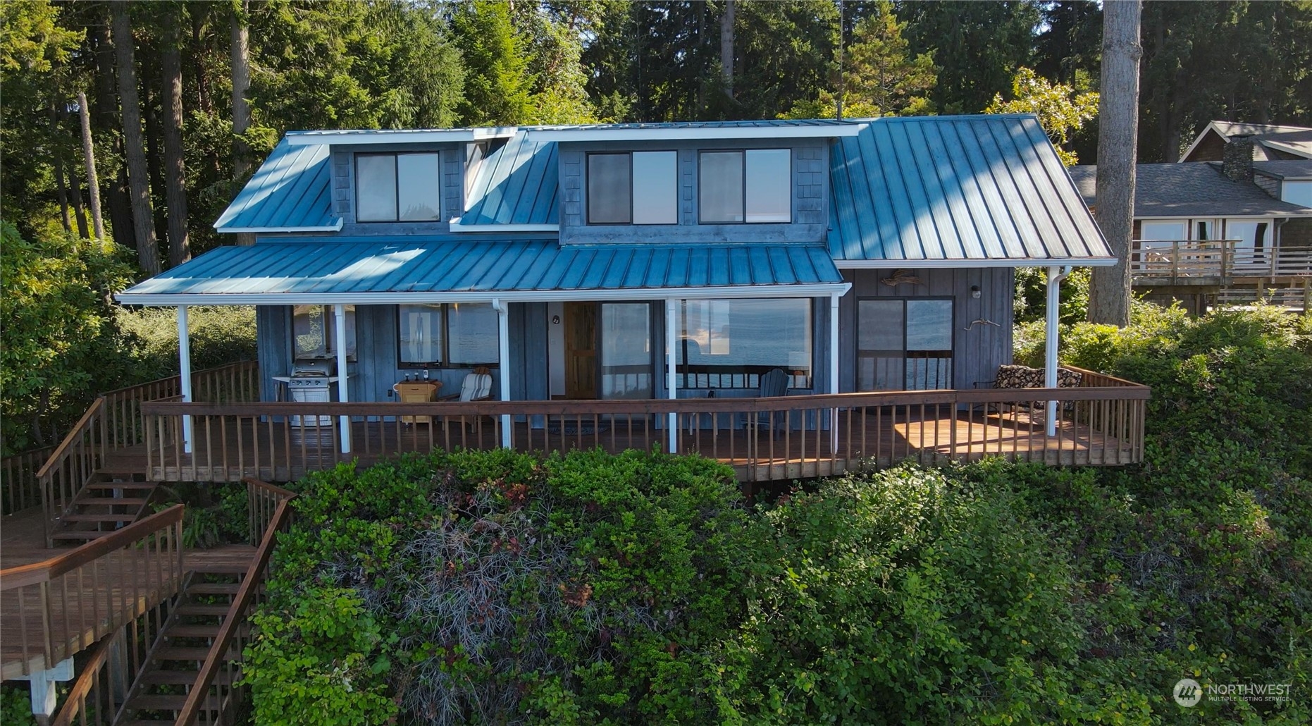14507 Outer Bay Road Anderson Island, WA 98303 - Photo 1 of 40 a view of a house with brick walls and a yard with plants