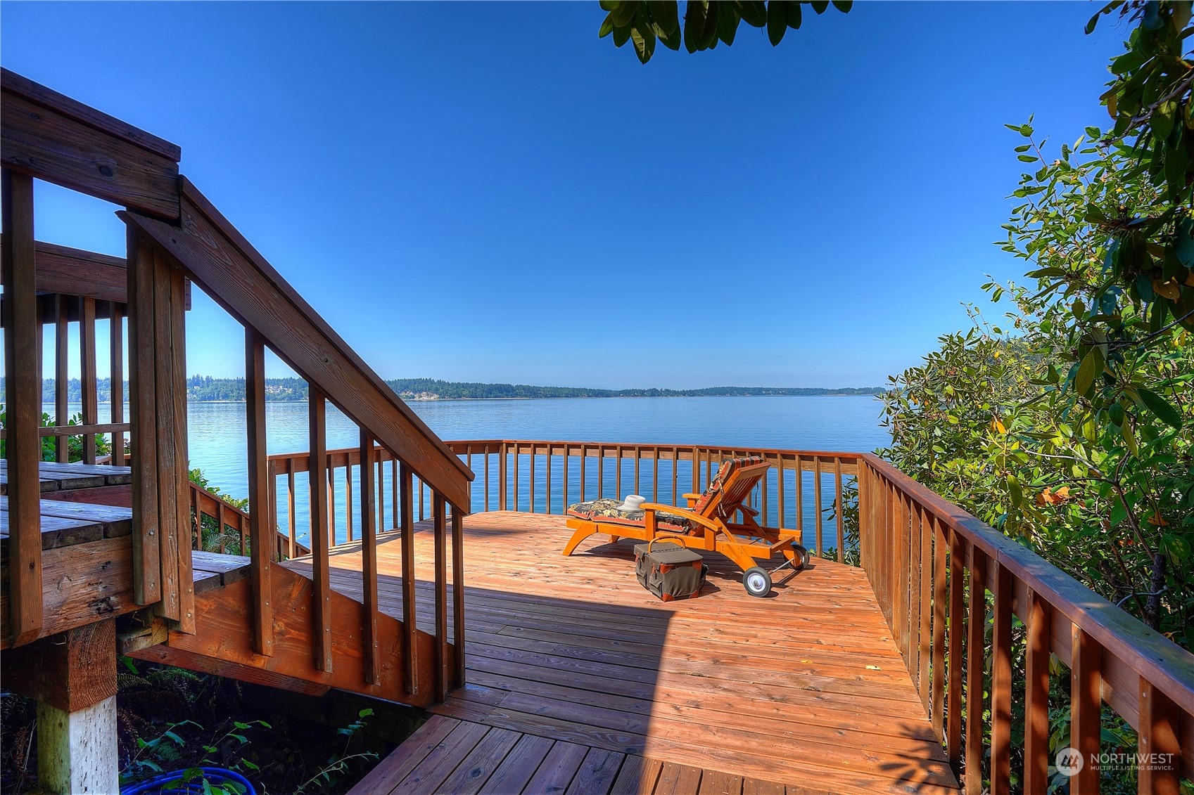 14507 Outer Bay Road Anderson Island, WA 98303 - Photo 13 of 40 a balcony with wooden floor and outdoor seating