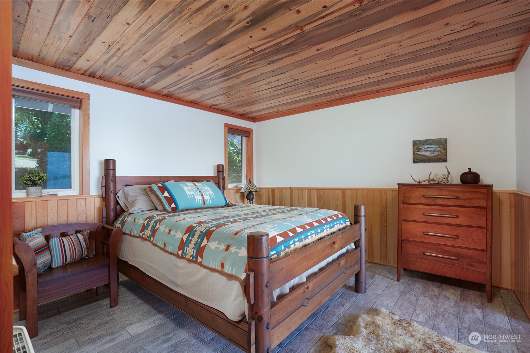 14507 Outer Bay Road Anderson Island, WA 98303 - Photo 19 of 40 a large bed sitting in a bedroom next to a window