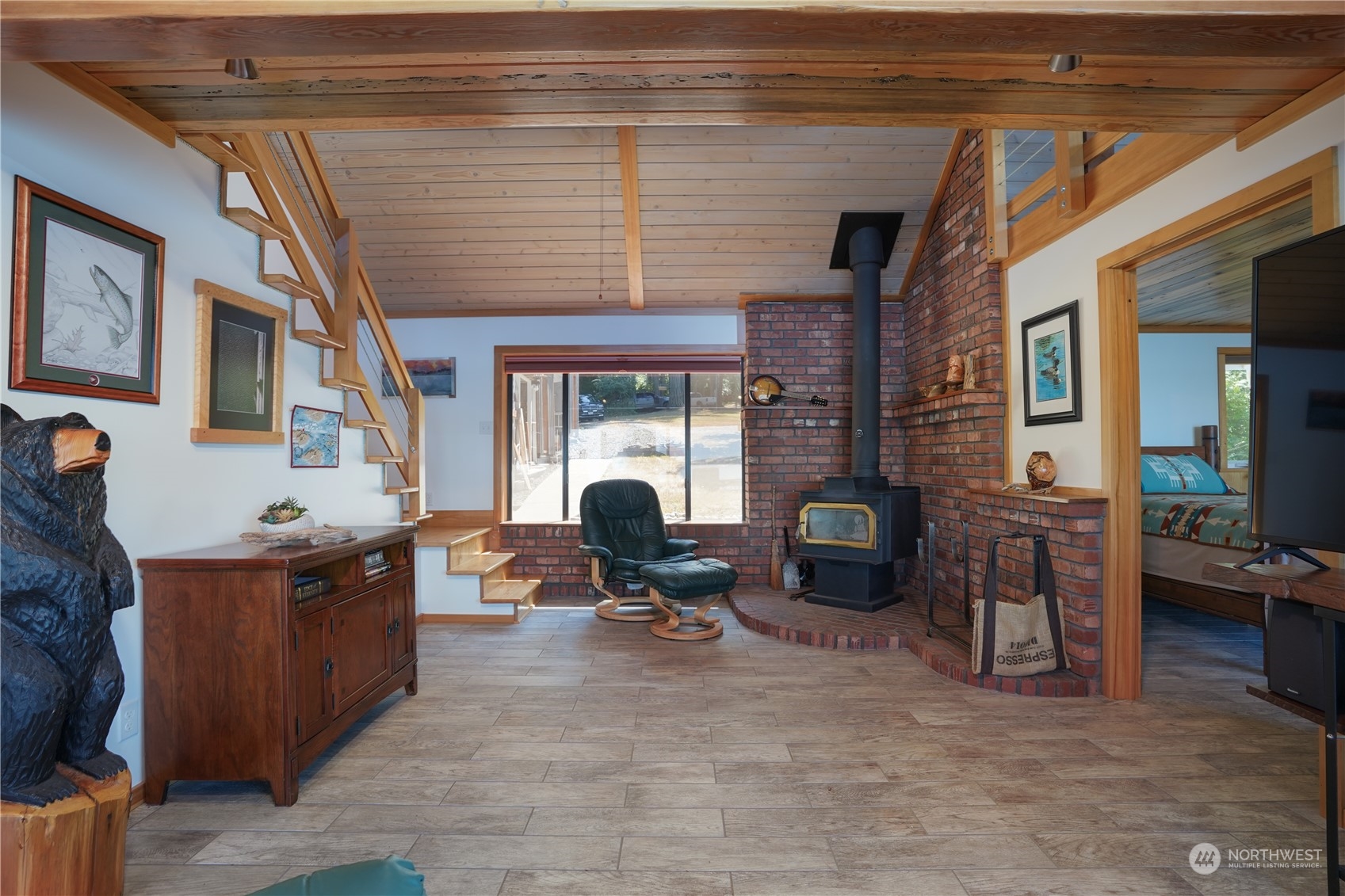 14507 Outer Bay Road Anderson Island, WA 98303 - Photo 21 of 40 a living room with furniture window and a fireplace