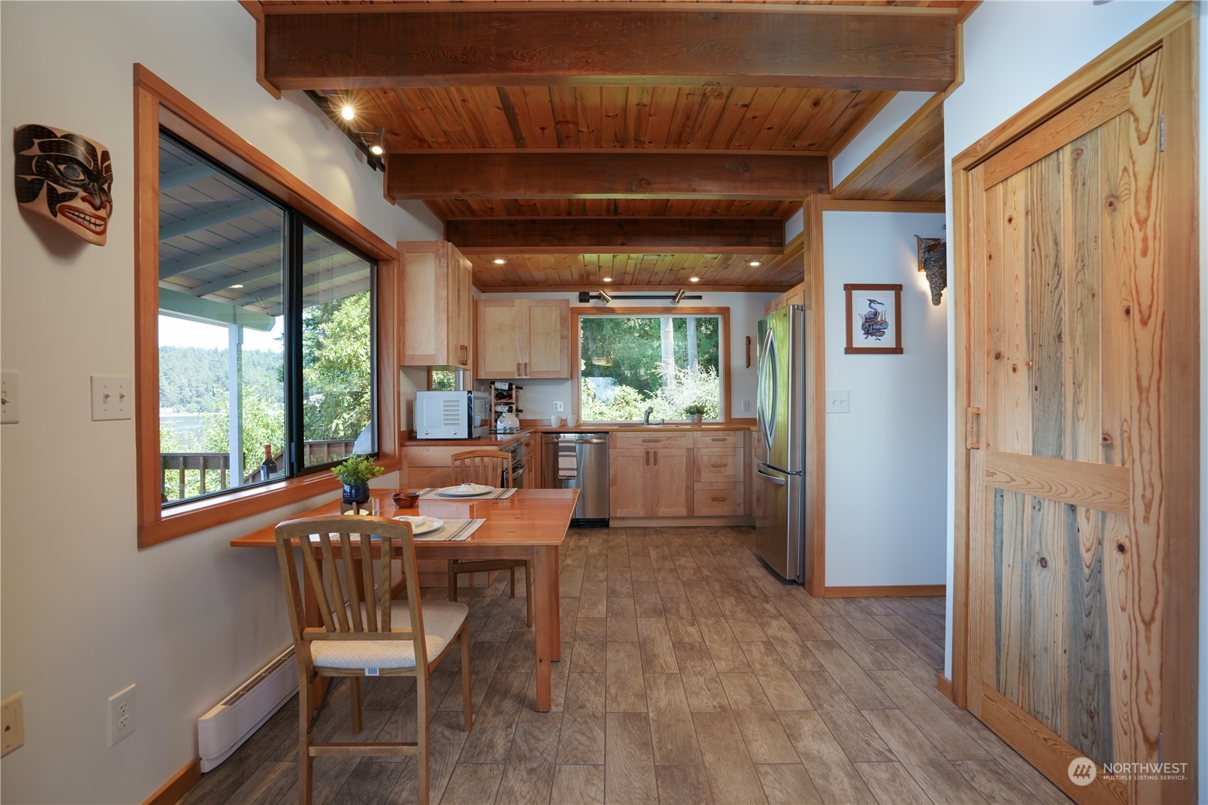 14507 Outer Bay Road Anderson Island, WA 98303 - Photo 25 of 40 a view of a dining room with furniture window and wooden floor