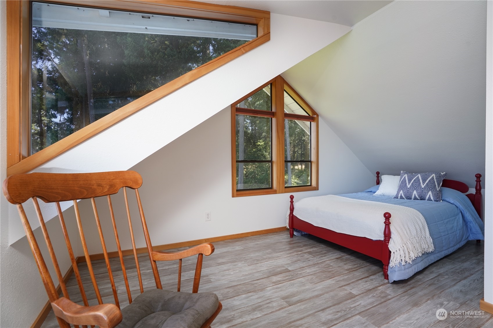 14507 Outer Bay Road Anderson Island, WA 98303 - Photo 29 of 40 a bedroom with a bed and wooden floor