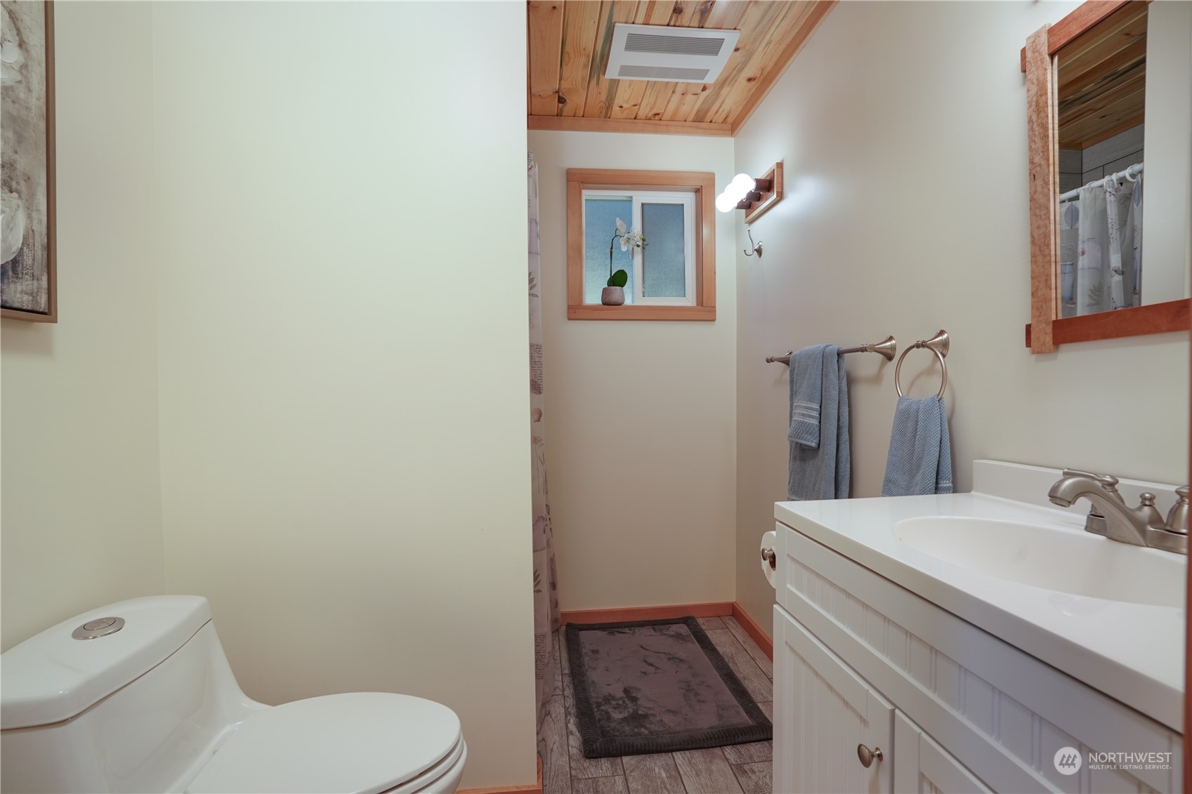 14507 Outer Bay Road Anderson Island, WA 98303 - Photo 30 of 40 a bathroom with a toilet a sink and mirror