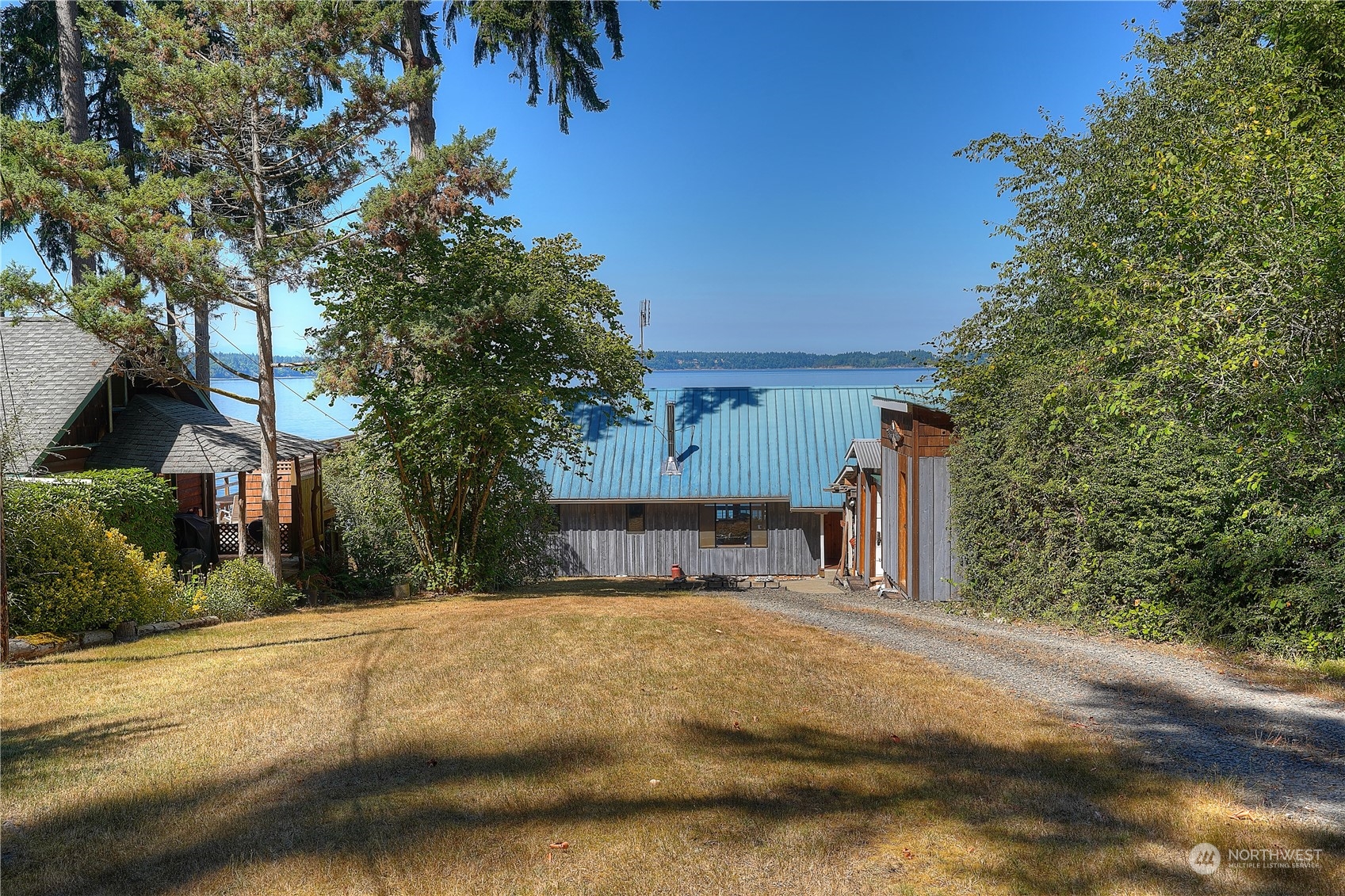14507 Outer Bay Road Anderson Island, WA 98303 - Photo 32 of 40 a view of a house with a yard