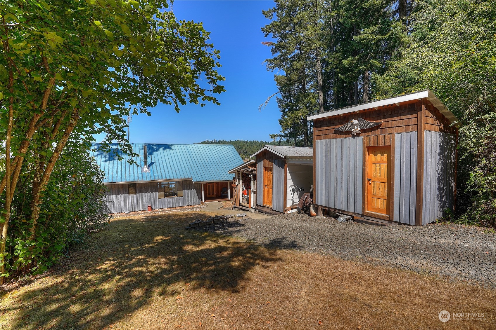 14507 Outer Bay Road Anderson Island, WA 98303 - Photo 33 of 40 a view of a house with large tree and wooden fence