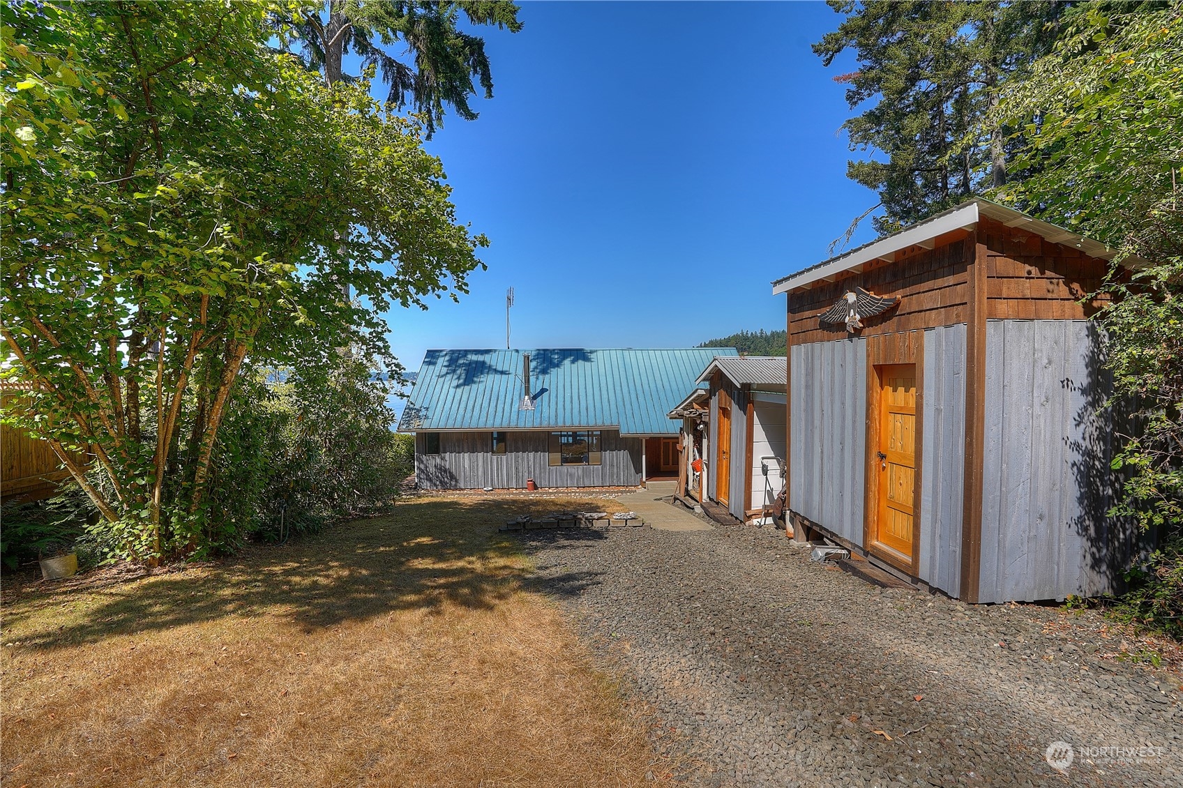 14507 Outer Bay Road Anderson Island, WA 98303 - Photo 34 of 40 a view of a house with a yard and garage