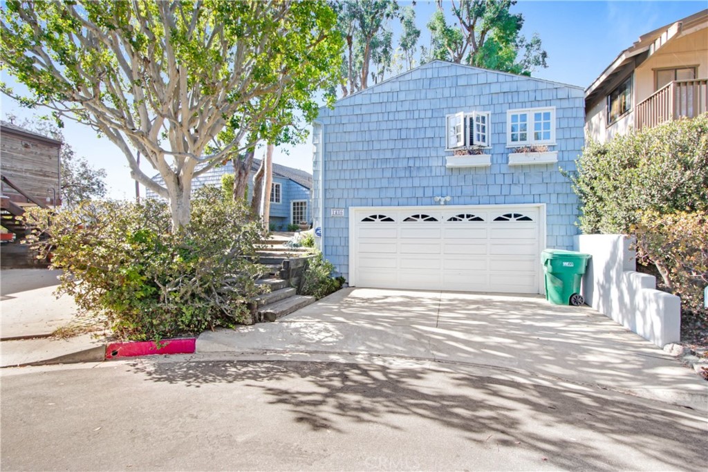 1486 Morningside Circle, Unit MAIN Laguna Beach, CA 92651 - Photo 11 of 24 a front view of a house with a yard and garage