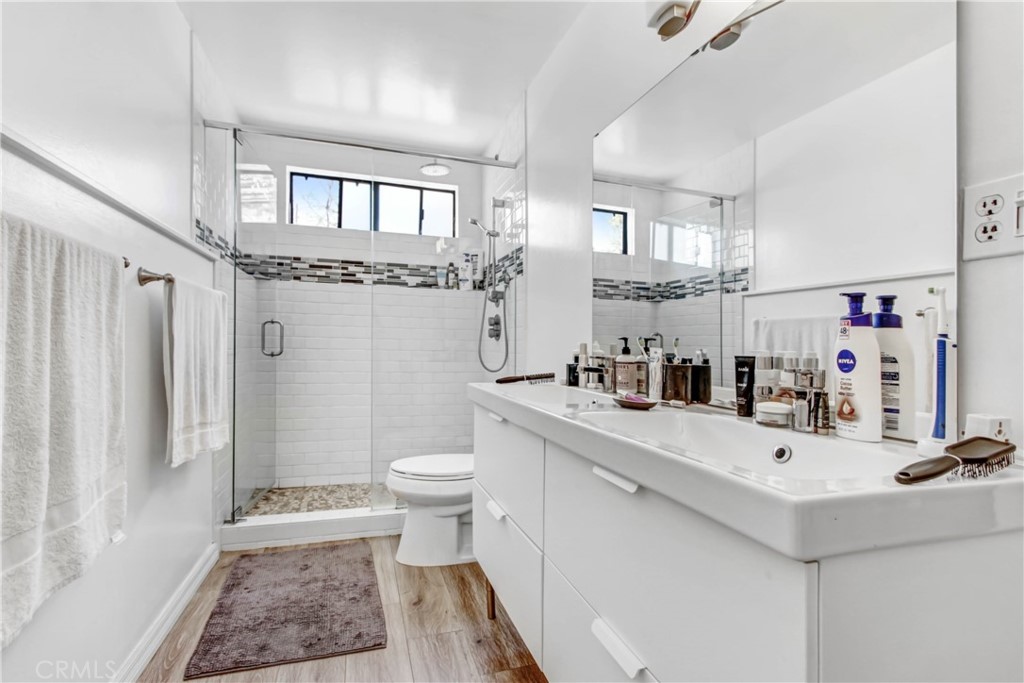 1486 Morningside Circle, Unit MAIN Laguna Beach, CA 92651 - Photo 21 of 24 a bathroom with a sink a toilet and a mirror
