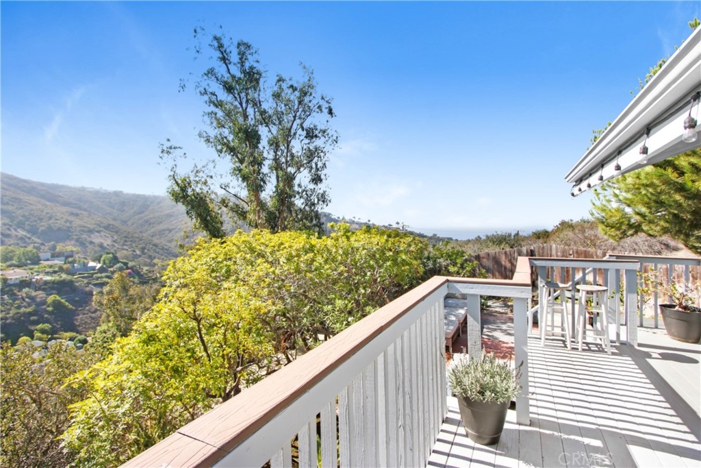 1486 Morningside Circle, Unit MAIN Laguna Beach, CA 92651 - Photo 4 of 24 a view of a balcony with wooden floor and a bench