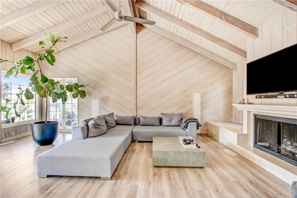 1486 Morningside Circle, Unit MAIN Laguna Beach, CA 92651 - Photo 7 of 24 a living room with furniture a flat screen tv and a fireplace