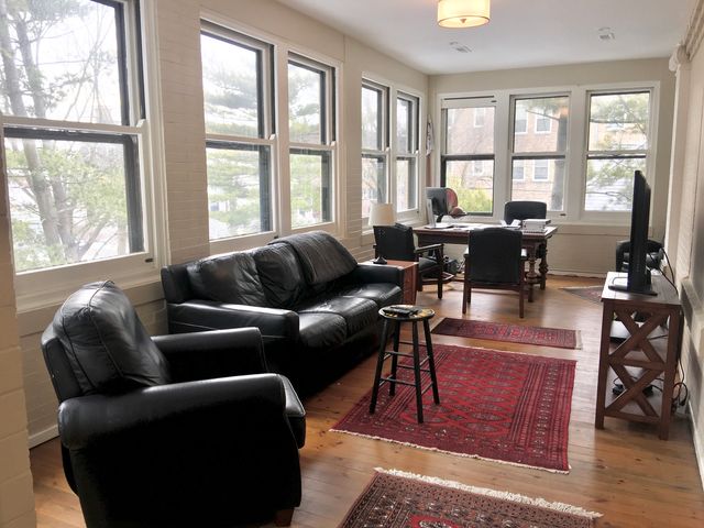 a spacious bedroom with a bed and a chandelier