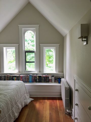 a living room with pool table and chairs