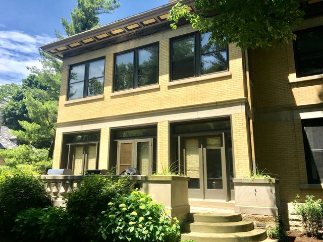 a view of a patio with table and chairs and potted plants