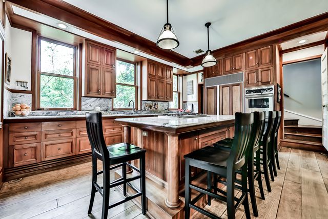 a dining table with chairs and window
