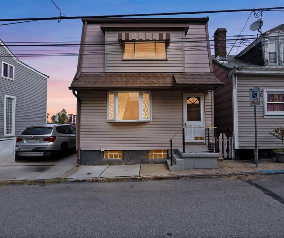 a view of a car park in front of house