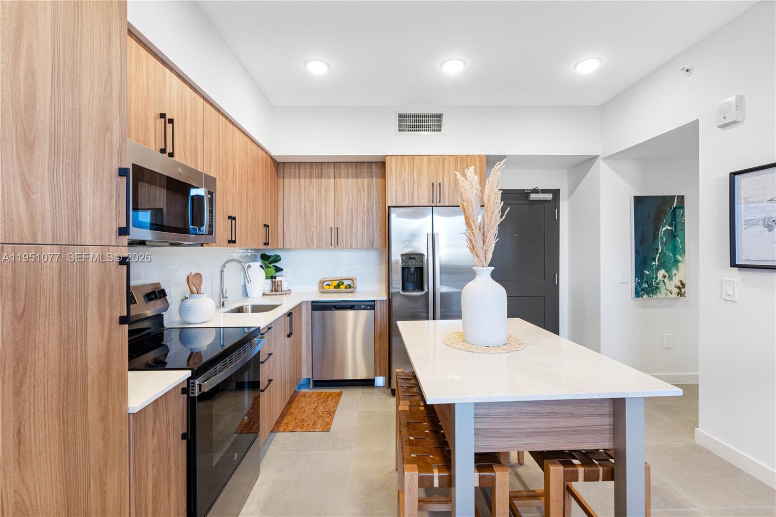 208 North Federal Highway, Unit 361 Pompano Beach, FL 33062 - Photo 6 of 25 a kitchen with granite countertop a sink a counter top space stainless steel appliances and cabinets