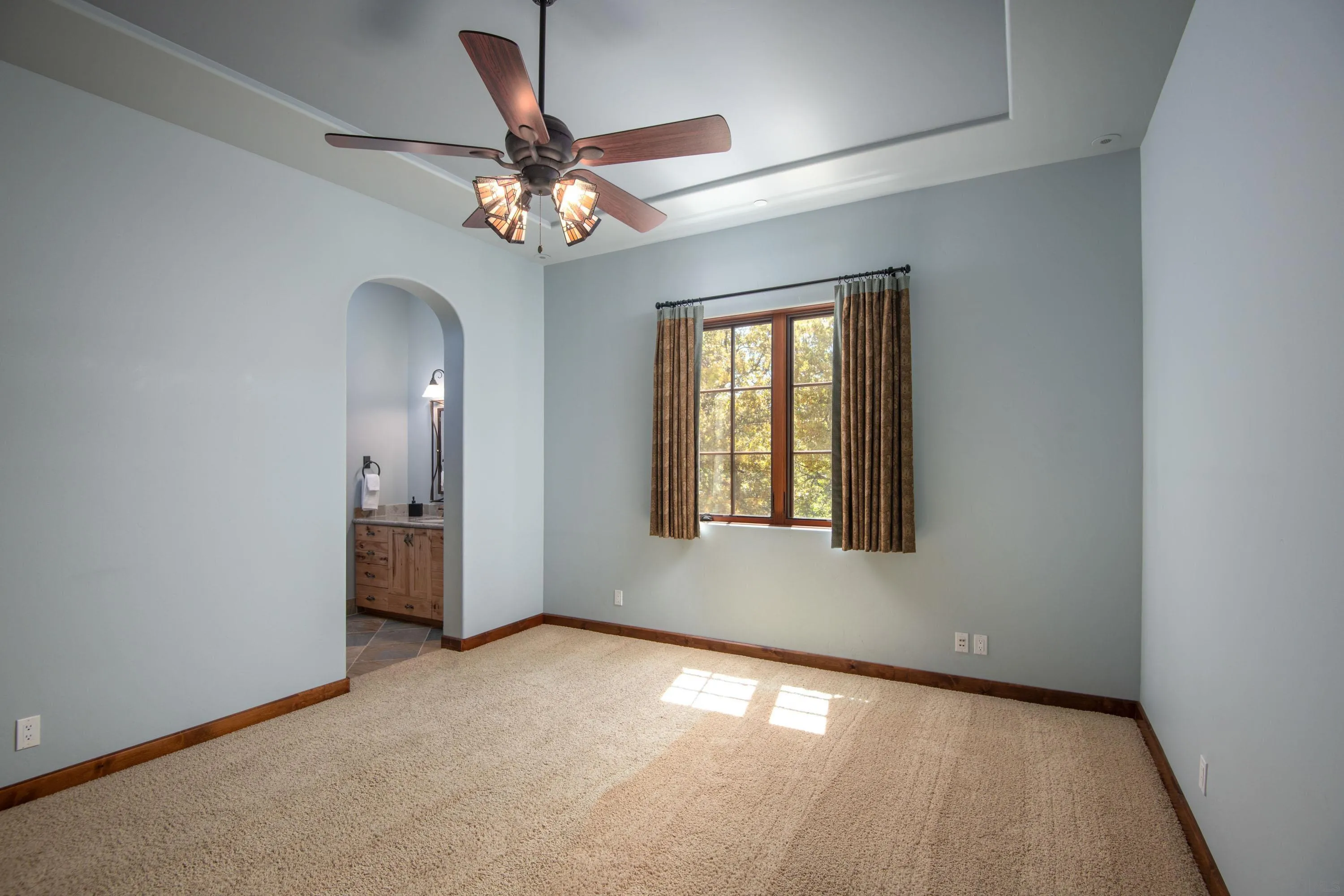 23835 Viejas Grade Road Descanso, CA 91916 - Photo 41 of 62 an empty room with a chandelier fan and windows