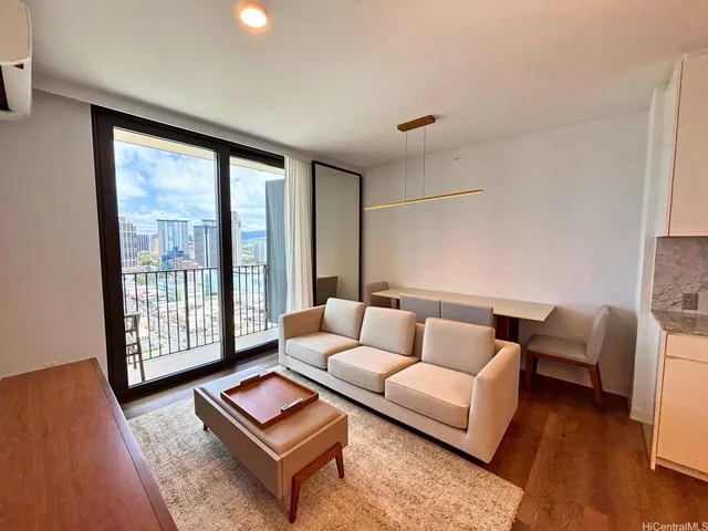 a living room with furniture and a floor to ceiling window