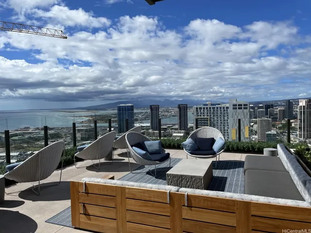 a view of a terrace with couches and sky view