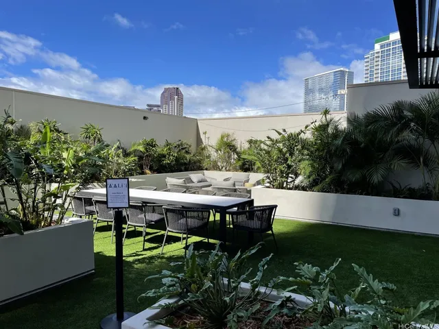 a view of a patio with table and chairs and potted plants