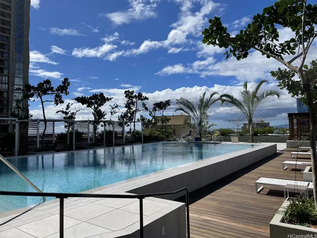 a view of a swimming pool with outdoor seating