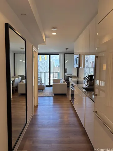 a view of a living room kitchen and a wooden floor