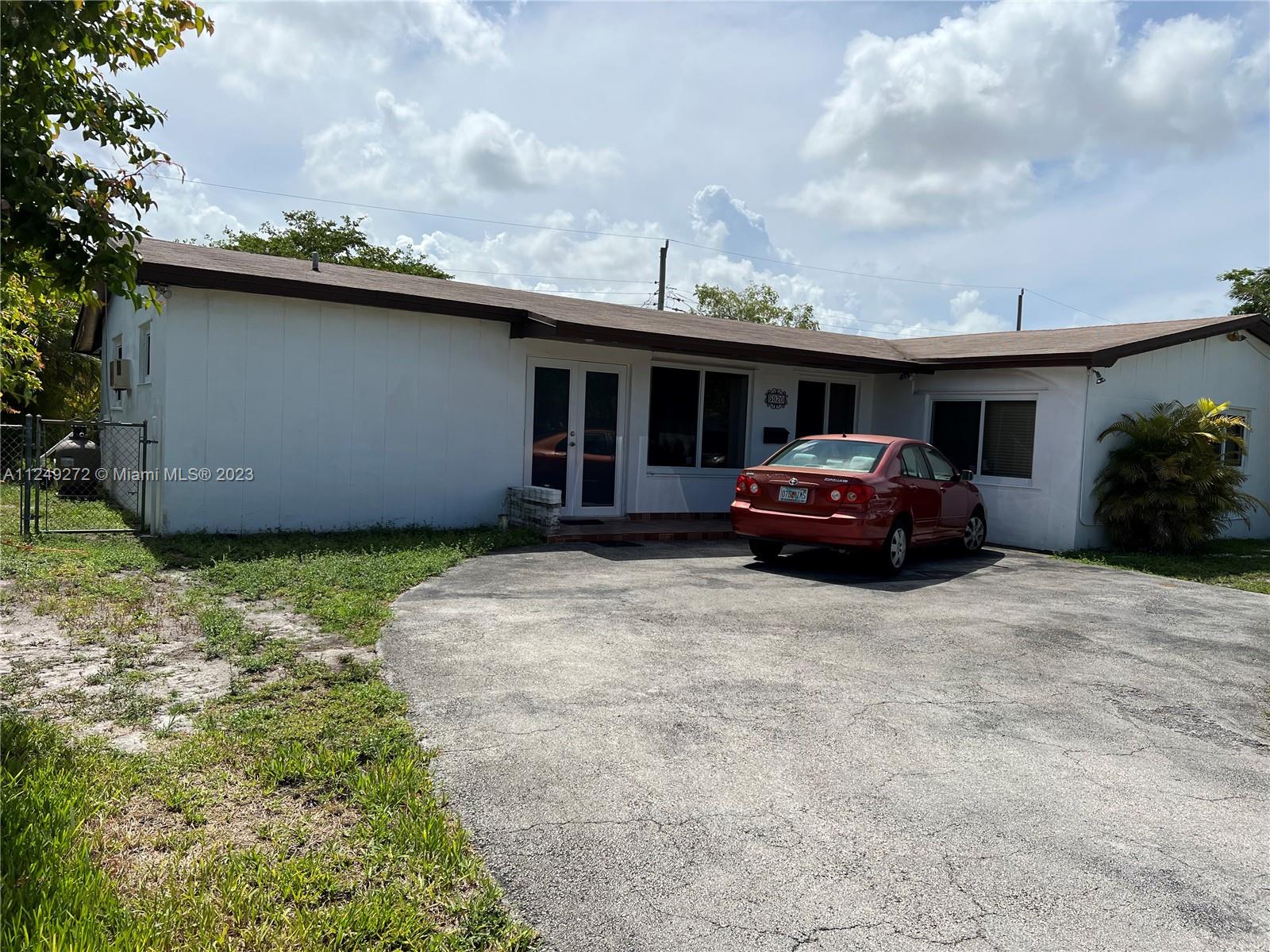 a car parked in front of white house