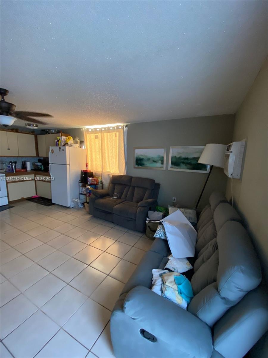 Sunset Miami, FL 33173 - Photo 11 of 18 a living room with furniture and a window