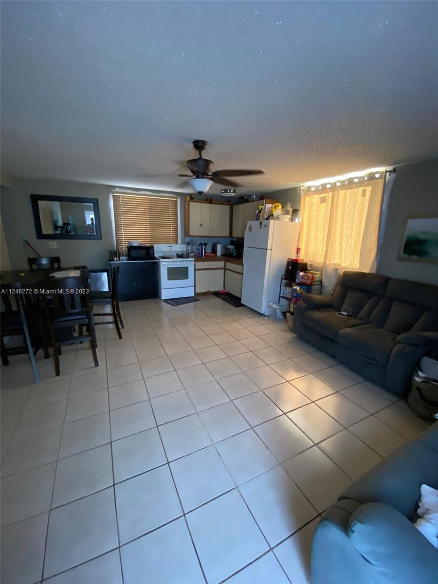 Sunset Miami, FL 33173 - Photo 12 of 18 a living room with furniture and a flat screen tv