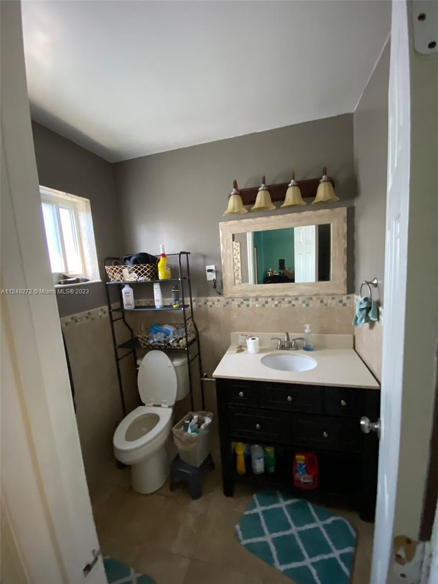 Sunset Miami, FL 33173 - Photo 7 of 18 a bathroom with a sink toilet and mirror