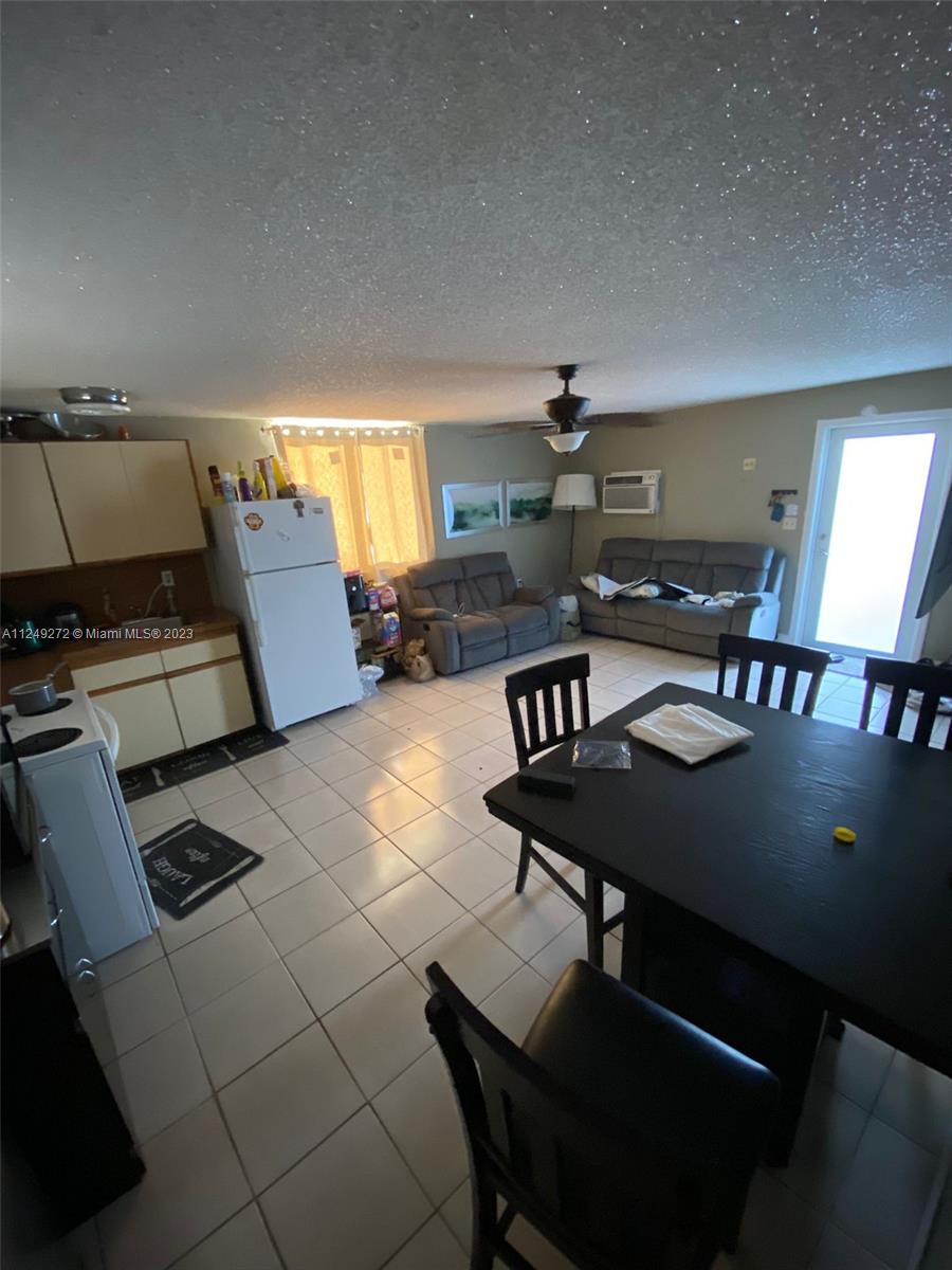 Sunset Miami, FL 33173 - Photo 8 of 18 a living room with furniture and a table