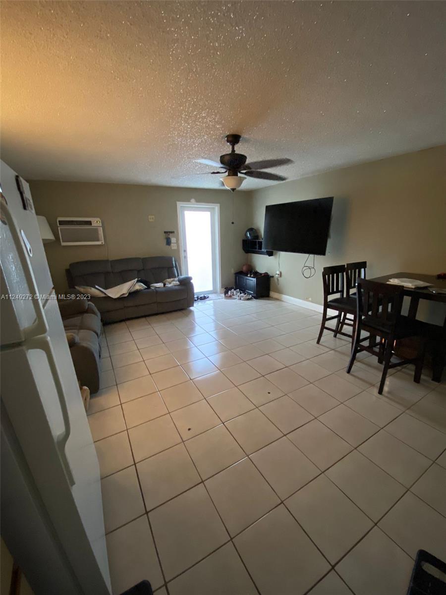Sunset Miami, FL 33173 - Photo 9 of 18 a living room with furniture and a flat screen tv