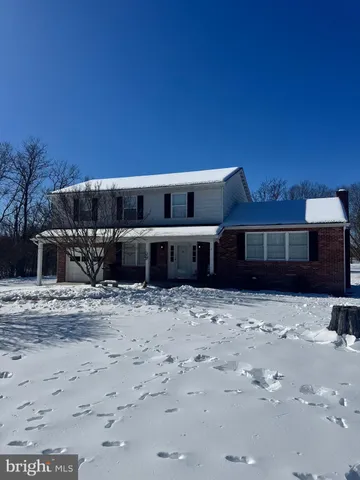 a backyard of a house with a yard and outdoor seating