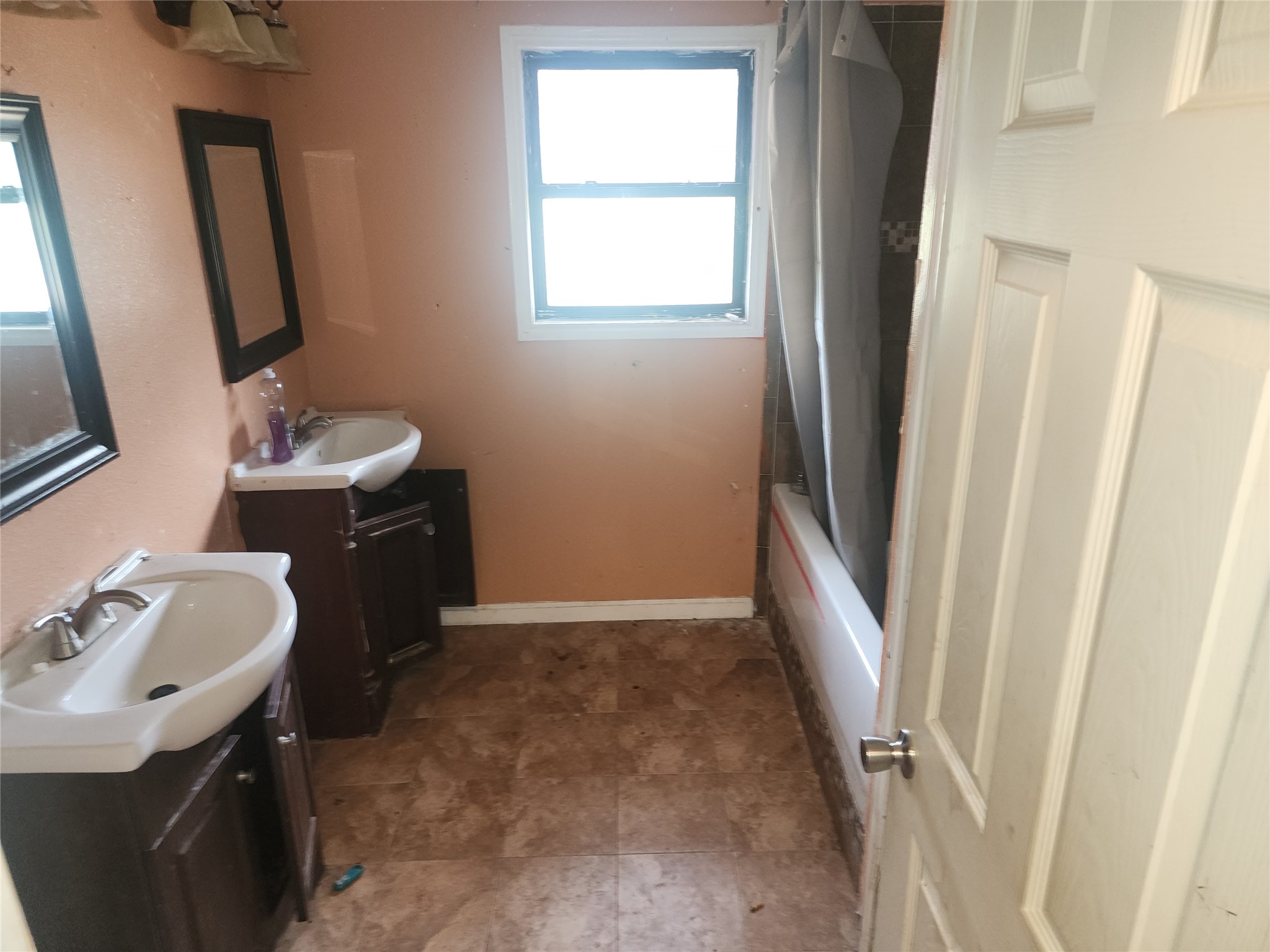14115 Bohemian Hall Road Crosby, TX 77532 - Photo 11 of 22 a bathroom with a sink a mirror a window and a bath tub