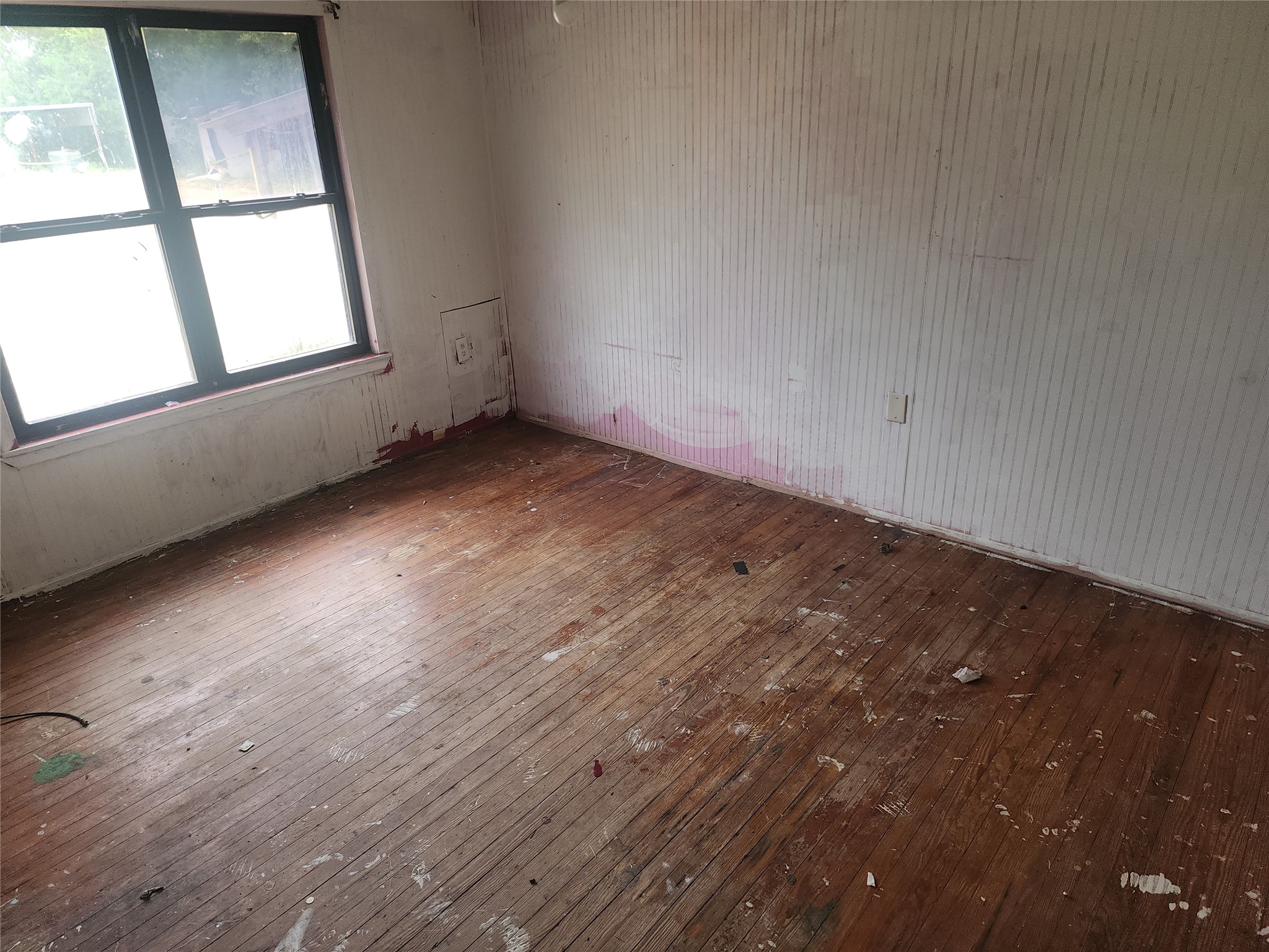 14115 Bohemian Hall Road Crosby, TX 77532 - Photo 12 of 22 an empty room with wooden floor and windows