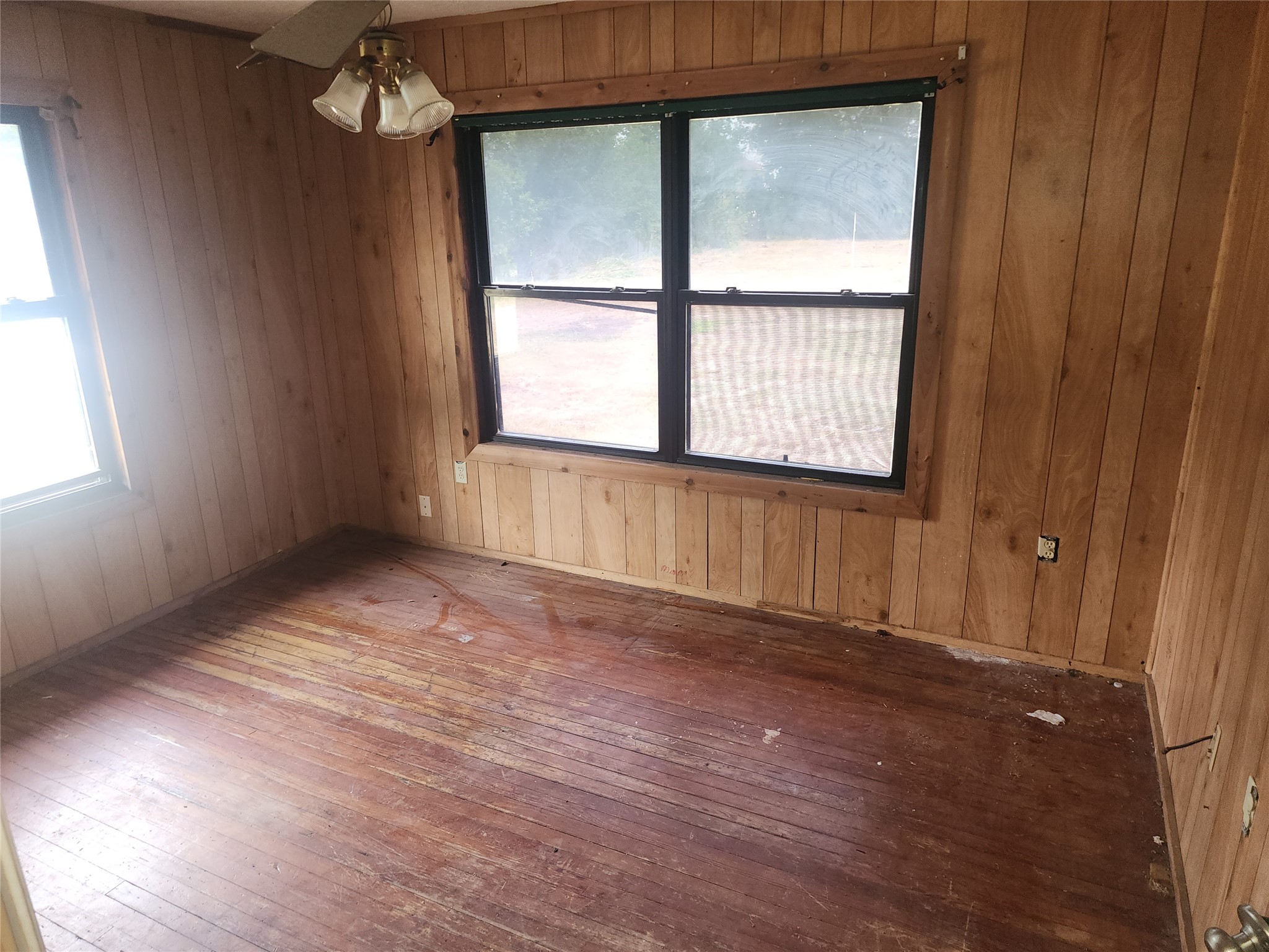 14115 Bohemian Hall Road Crosby, TX 77532 - Photo 13 of 22 an empty room with wooden floor and windows