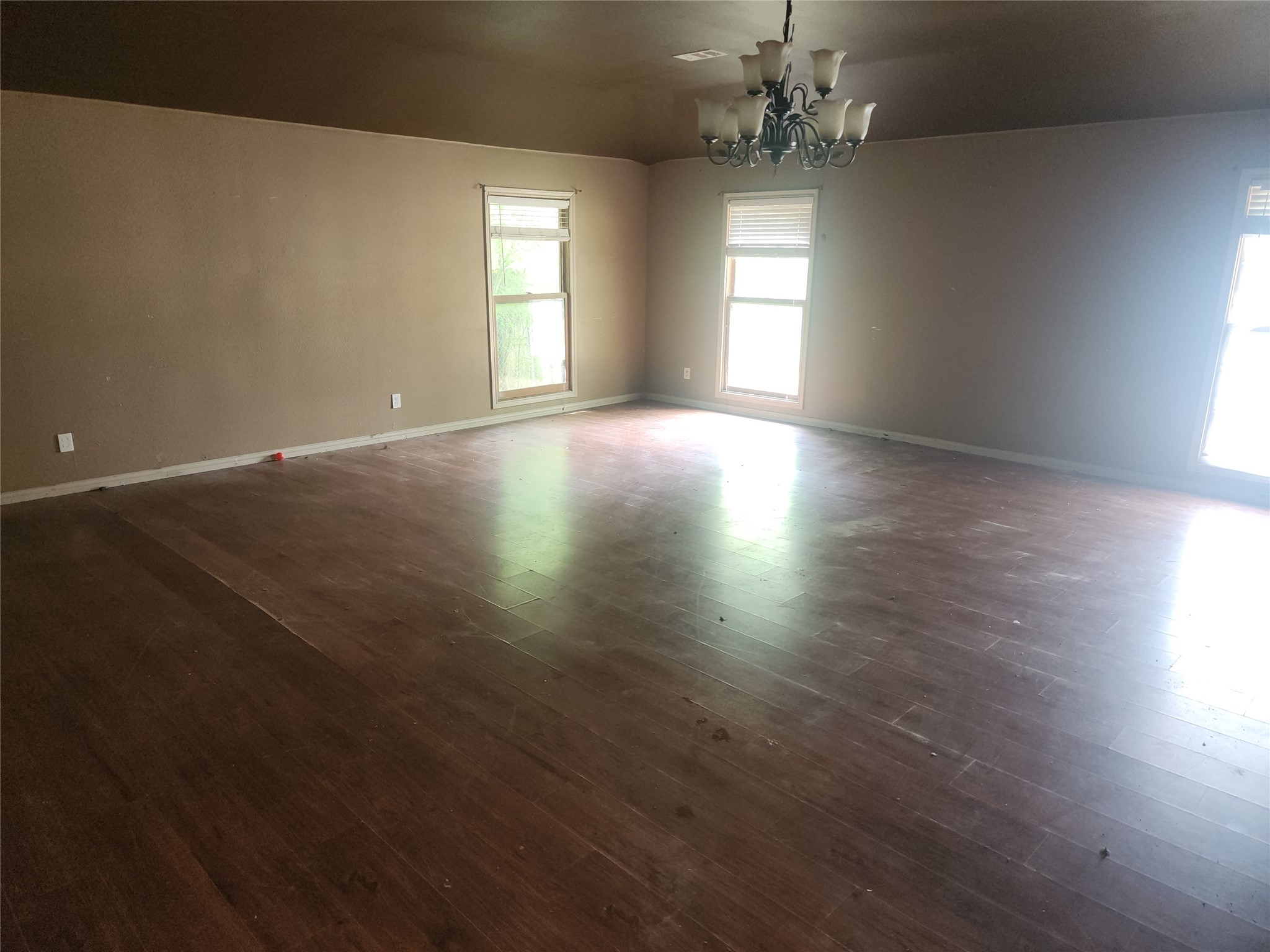14115 Bohemian Hall Road Crosby, TX 77532 - Photo 17 of 22 an empty room with wooden floor and windows