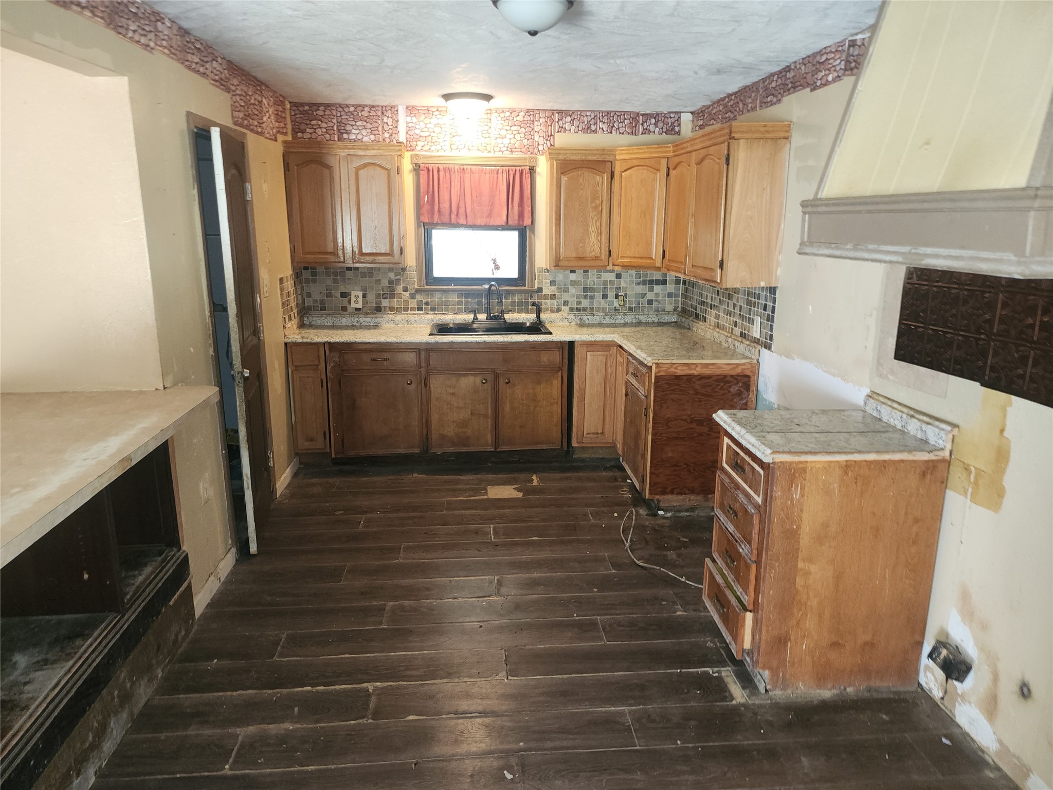 14115 Bohemian Hall Road Crosby, TX 77532 - Photo 20 of 22 a kitchen with granite countertop a sink a counter space and cabinets
