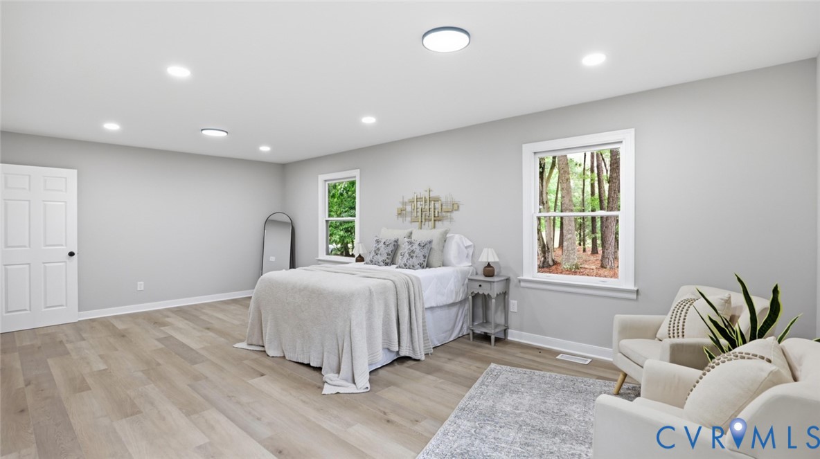 3200 Portugee Road Sandston, VA 23150 - Photo 17 of 26 a spacious bedroom with a large bed and a window