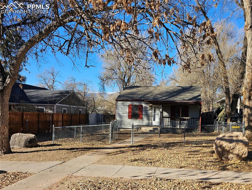 812 Alexander Road Colorado Springs, CO 80909 - Photo 1 of 8 a front view of a house with a yard