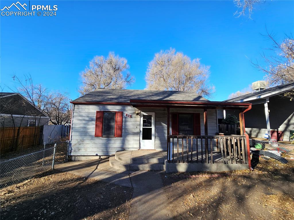 812 Alexander Road Colorado Springs, CO 80909 - Photo 2 of 8 a front view of a house with a porch