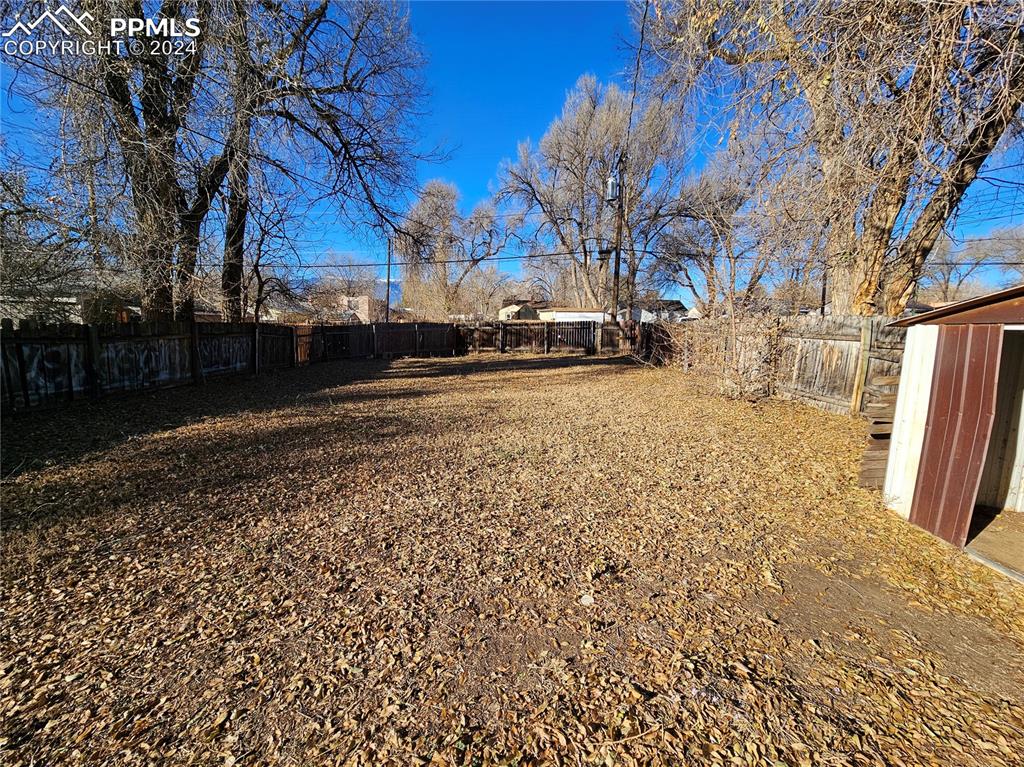 812 Alexander Road Colorado Springs, CO 80909 - Photo 5 of 8 a view of a yard with snow on the tree