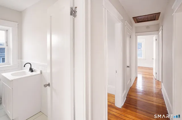 a view of a hallway with wooden floor