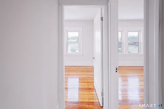 a view of a livingroom with wooden floor and white walls