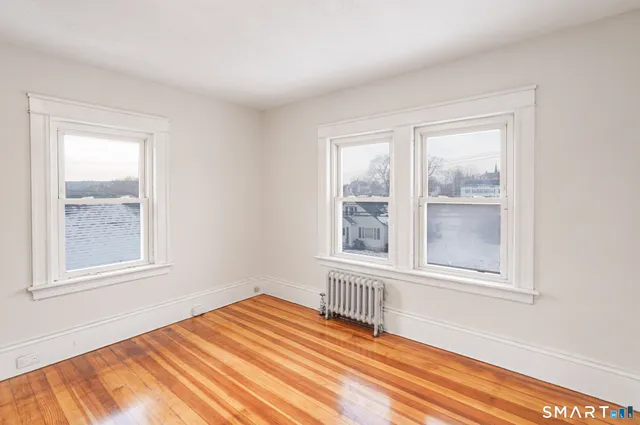 a view of a room with wooden floor and window
