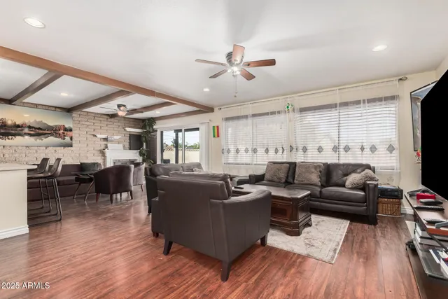 a living room with lots of furniture and wooden floor